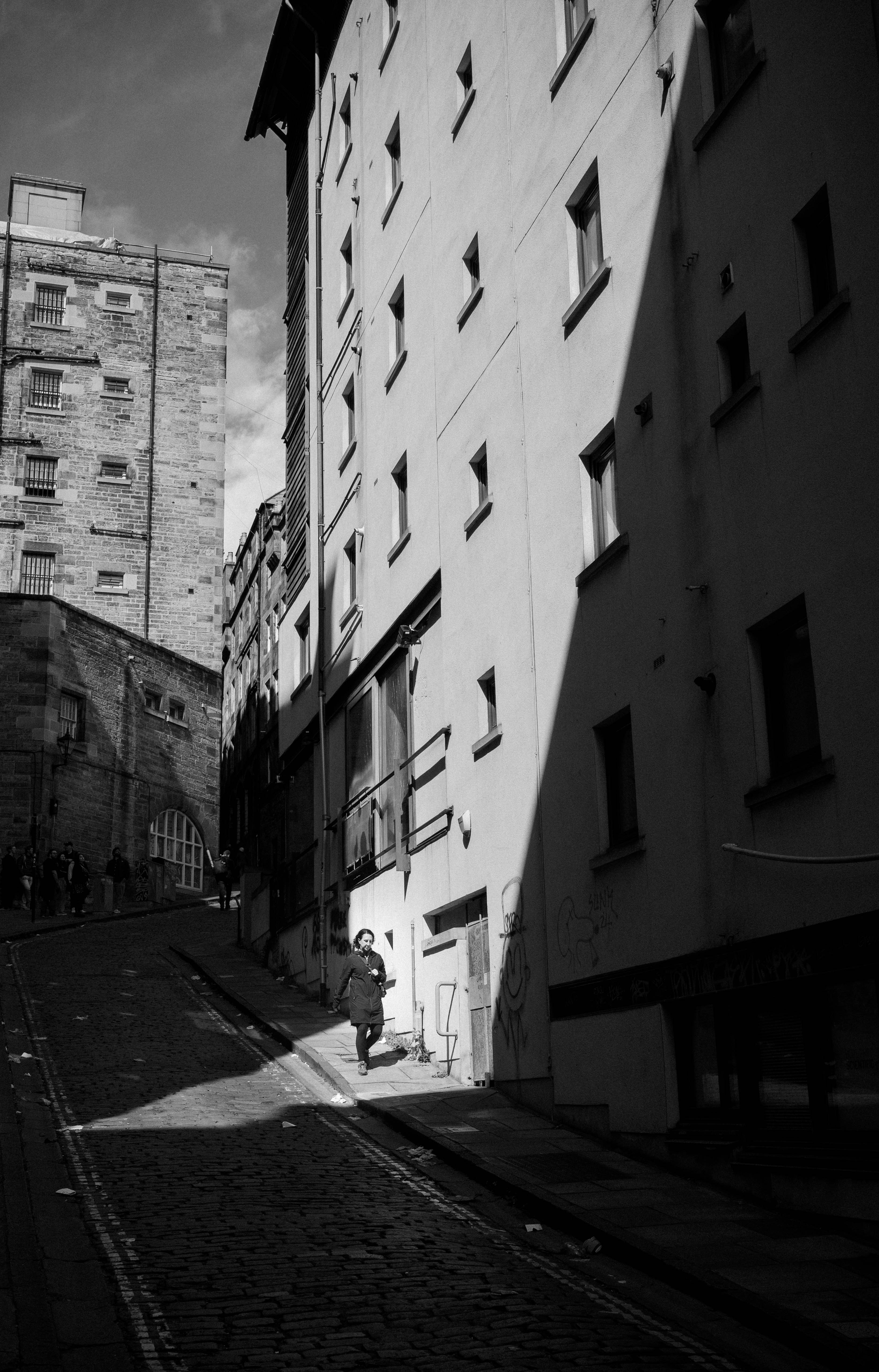 High-contrast light and shadow play along Cowgate